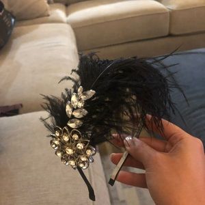 woman’s feathered and jeweled hair accessory